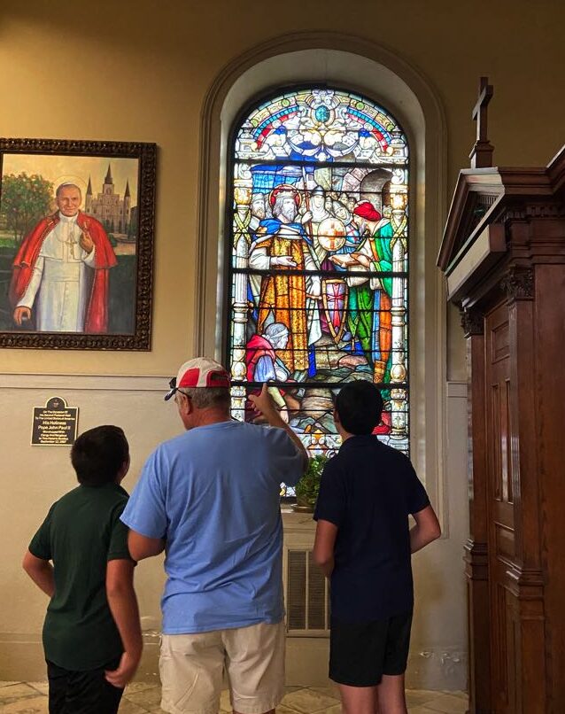 Tom Vail discussing the meaning of a stained glass window with Robert and Ben in St. Louis Cathedral - New Orleans, LA.