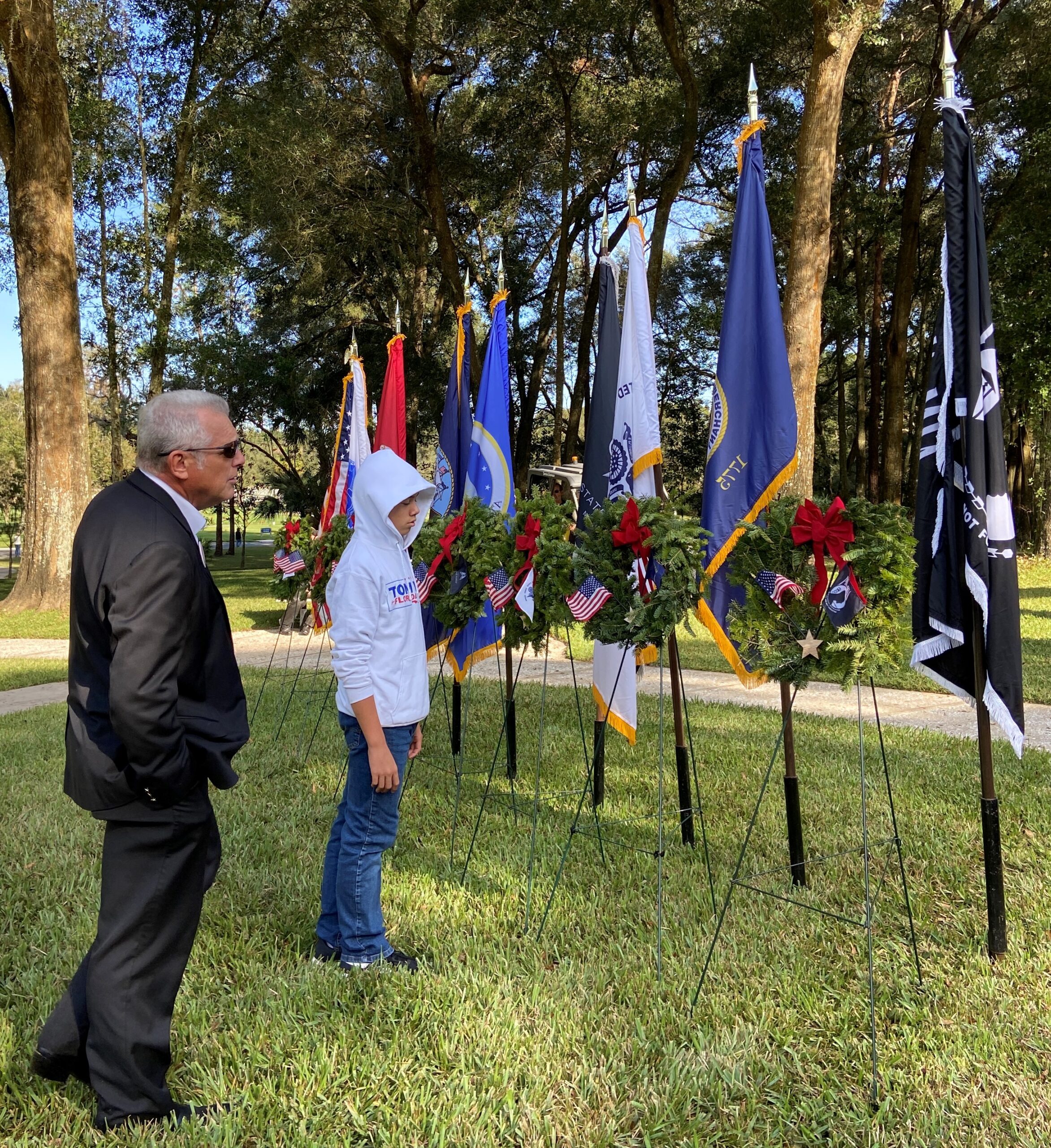 Tom and Ben Vail viewing military flags